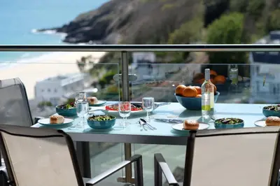 a table with food and drinks on a balcony at The Boats in St Ives