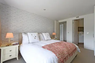 a bedroom with a large white bed with white pillows at The Boats in St Ives