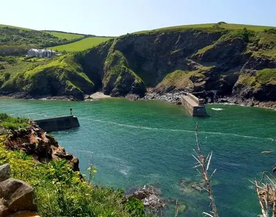 a body of water with a boat in it at Bre Cottage in Port Isaac