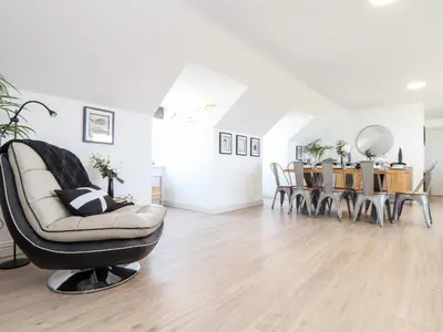 a living room with a chair and a table at Penthouse 23 in Newquay