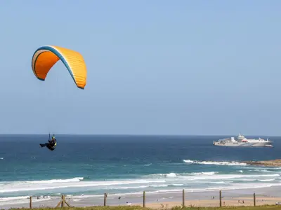 a person flying a kite over the beach at Penthouse 23 in Newquay