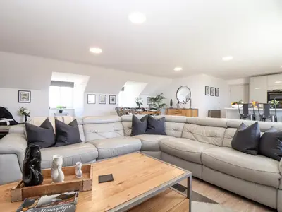 a living room with a couch and a table at Penthouse 23 in Newquay