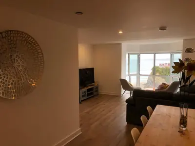 a living room with a couch and a table at The Towan Lookout in Newquay