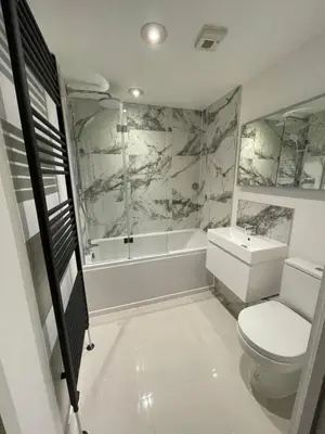 a bathroom with a toilet and a tub and a sink at The Towan Lookout in Newquay