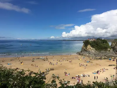 a group of people on a beach near the ocean at The Towan Lookout in Newquay