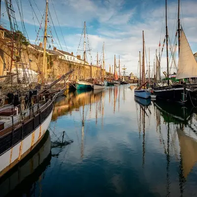 a group of boats are docked in a harbor at Hillside in St Austell