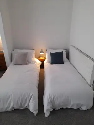 two beds sitting next to each other in a room at Bosloe in Helston