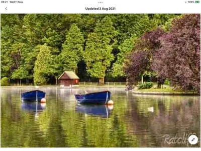 two boats sitting in the water in a lake at Bosloe in Helston