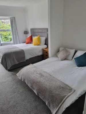 two beds sitting next to each other in a bedroom at Bosloe in Helston