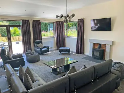 a living room with a couch and a fireplace at The Hurlers in Saint Cleer