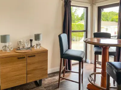 a room with a table and chairs and a table and a window at The Hurlers in Saint Cleer