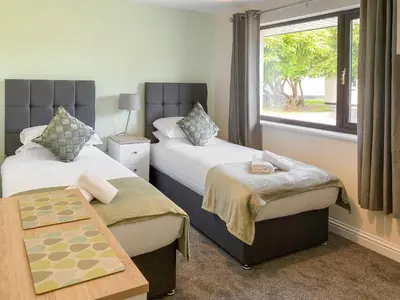 a hotel room with two beds and a window at The Hurlers in Saint Cleer