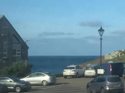 a group of cars parked in a parking lot at Island View - 3 Bedroom Holiday Cottage - 40m to Porthgwidden Beach - Sleeps 7 - inc FREE Parking in St Ives