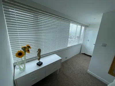 a room with a window with a sunflower on a table at Island View - 3 Bedroom Holiday Cottage - 40m to Porthgwidden Beach - Sleeps 7 - inc FREE Parking in St Ives