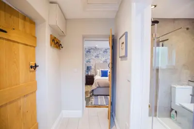 a hallway with a door leading to a bedroom at Sleepers Barn in Saint Teath