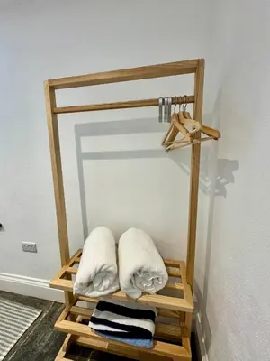 a wooden towel rack with two towels on it at Sleepers Barn in Saint Teath