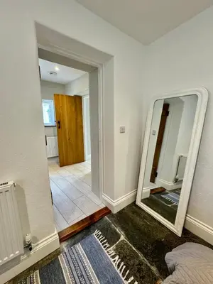 a room with a mirror and a hallway at Sleepers Barn in Saint Teath