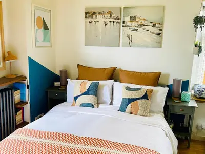 a bedroom with a bed with pillows on it at St Ives Balcony Flat TreCar in St Ives