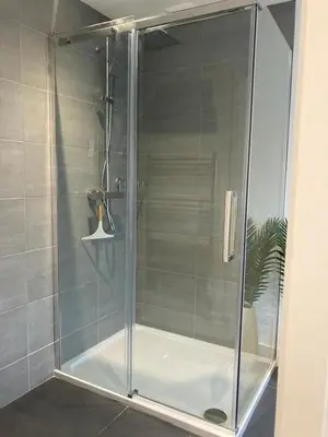 a shower with a glass door in a bathroom at Saffron in Saint Columb Minor