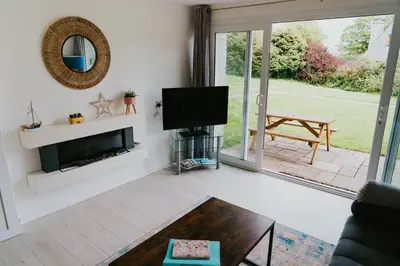 a living room with a tv and a fireplace at Newquay Holiday Home in Newquay