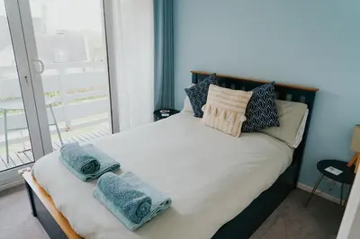 a bedroom with a bed with towels on it at Newquay Holiday Home in Newquay