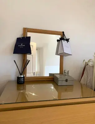 a desk with a mirror and a box and a light at Romantic hideaway, seconds away from Perran beach in Perranporth