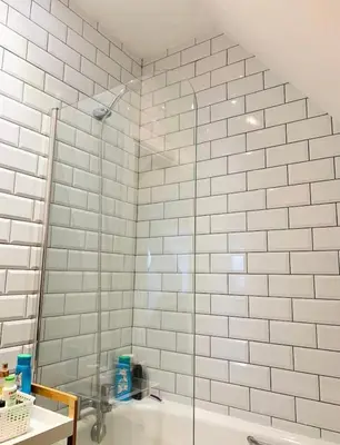 a glass shower in a bathroom with a sink at Romantic hideaway, seconds away from Perran beach in Perranporth