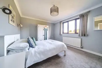 a bedroom with two beds and a window at Venn Down Lakes in Boscastle