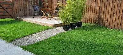a patio with a table and chairs and some grass at Rockley Cottage, close to Eden project and Fowey. in Bodmin