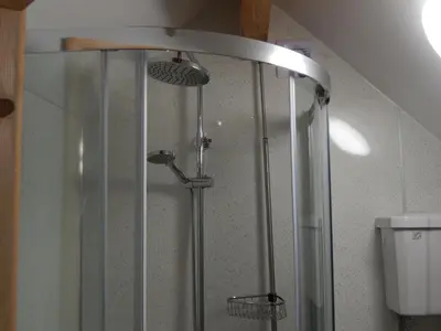 a shower with three shower heads in a bathroom at Rockley Cottage, close to Eden project and Fowey. in Bodmin