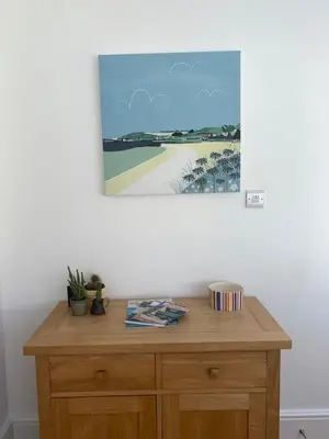 a wooden desk in a room with a painting on the wall at Puffin. Comfortable Annexe Central Falmouth in Falmouth