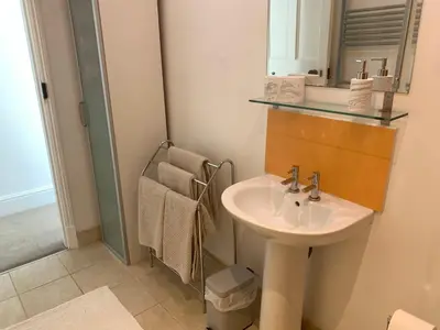 a bathroom with a sink and a mirror at Puffin. Comfortable Annexe Central Falmouth in Falmouth