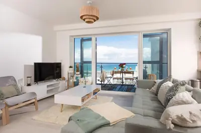 a living room with a view of the ocean at 45 Ocean 1, Newquay in Crantock