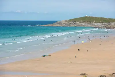 a group of people on a beach with the ocean at 45 Ocean 1, Newquay in Crantock