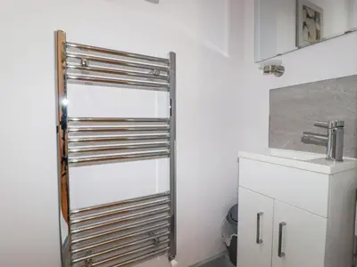 a kitchen with a stainless steel door next to a sink at 6 Ocean Heights in Newquay