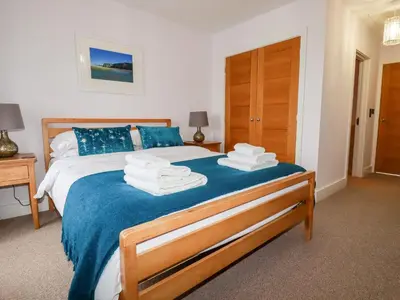 a bedroom with a bed with towels on it at 6 Ocean Heights in Newquay