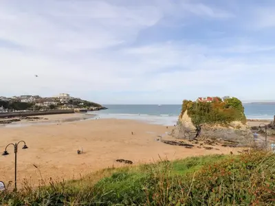 a beach with people on the sand and the ocean at 6 Ocean Heights in Newquay