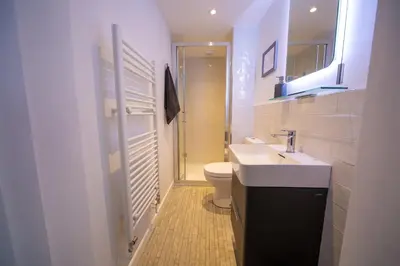 a white bathroom with a sink and a toilet at Trelowen in Padstow