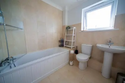 a bathroom with a tub and a toilet and a sink at Trelowen in Padstow