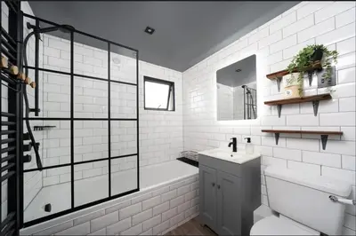 a white bathroom with a tub and a sink at Stunning Waterfront Apartment With Spectacular Views & Parking at 'CAPTAINS LOFT' in Falmouth