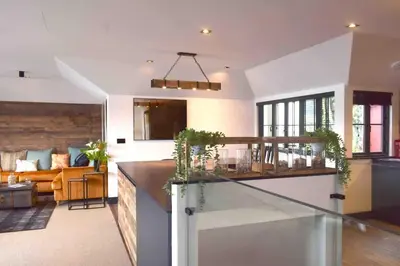a kitchen and living room with a counter and a couch at Stunning Waterfront Apartment With Spectacular Views & Parking at 'CAPTAINS LOFT' in Falmouth
