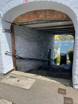a stone wall with an archway in a building at Stunning Waterfront Apartment With Spectacular Views & Parking at 'CAPTAINS LOFT' in Falmouth
