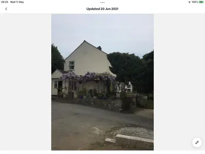 a house with flowers on the side of it at Bosloe in Helston