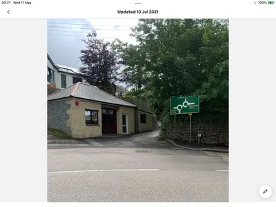 a street sign in front of a building with a sign at Bosloe in Helston