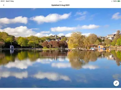 a view of a lake with trees and clouds in the water at Bosloe in Helston