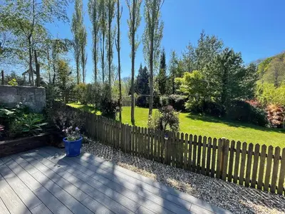 a wooden fence in front of a garden at The Potting Shed in St Austell