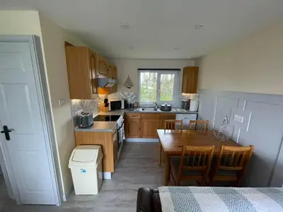 a kitchen with a table and a dining room at 81 Hengar Manor in Bodmin
