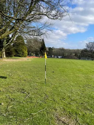 a yellow flag in the middle of a grass field at 81 Hengar Manor in Bodmin