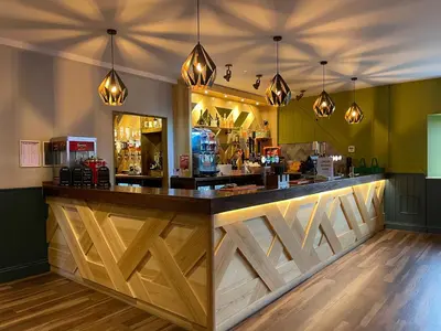 a bar with wooden counter tops in a restaurant at 81 Hengar Manor in Bodmin