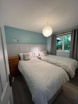 a bedroom with two beds and a window at 81 Hengar Manor in Bodmin
